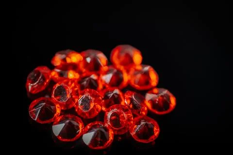 Macro shot of multiple bright red faceted gemstones. Stock Photos