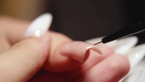 Macro Shot of Nail Technician Applying Gel Polish with Small Brush Stock Footage 316757838