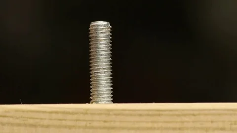Macro shot of a nut and bolt on wood Stock Footage 72558551