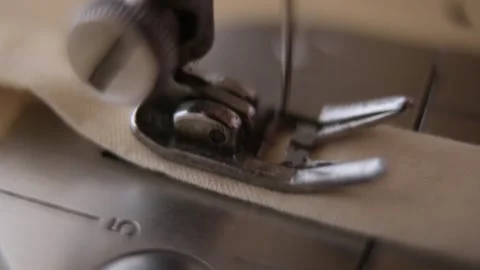 A macro shot from an old sewing machine working on a piece of cloth in southeast Stock Footage 264528478