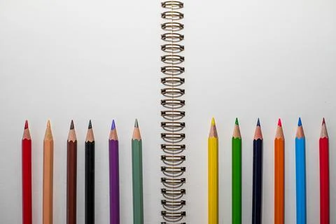 Macro shot: open notebook with white sheets on the table and lots of colored  Stock Photos