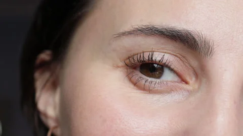 Macro shot opening and closing deep eyes adult lady. Stock Footage 154403153