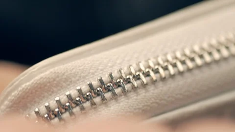 Macro shot of opening white wallet, unzipping zipper Video stock 100089102