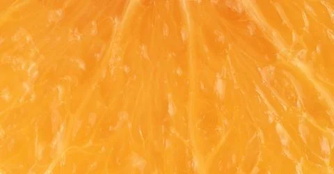 Macro shot of orange fruit texture. Food background Stock Photos