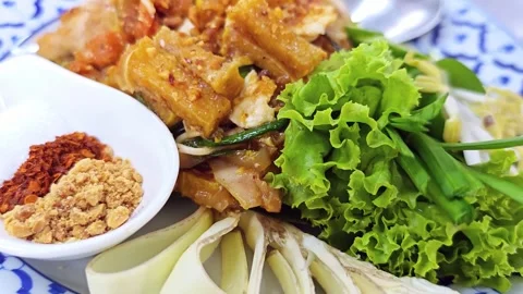 Macro shot of Pad Thai condiments and fresh vegetables garnish. Stock Footage 342403773