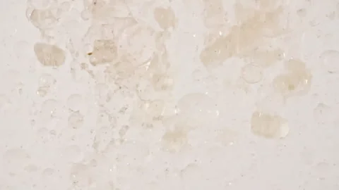 Macro Shot of Particles made of Powder, Cosmetic Texture in Water Descend up on Stock Footage 256479863