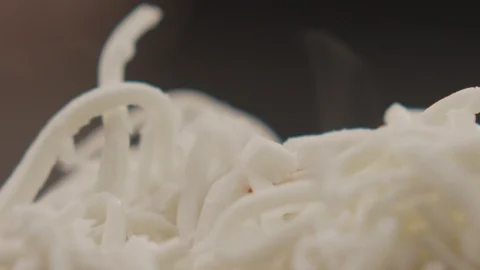 Macro shot of pasta with chicken sprinkled with cheese in slow motion Stock Footage 114360835