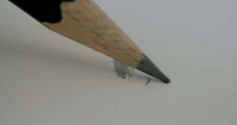 Macro shot of a pencil scribbling some lines into a notebook. side view. Stock Footage 116251532