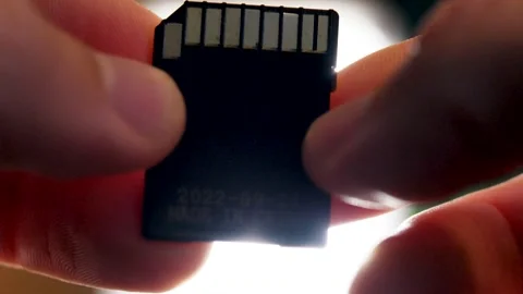 Macro shot of a person holding an SD card in their hands Stock Footage 299674600