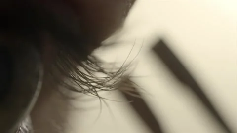 Macro shot of a person using tweezers for precise eyelash removal Stock Footage 336226483