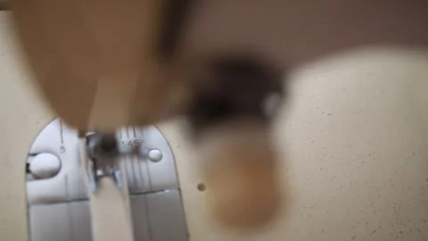 A macro shot from pieces from an old sewing machine working on a piece of cloth  Stock Footage 264528516