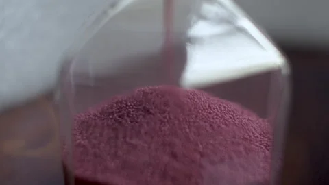 Macro Shot Of Pink  Coloured Sand Particles In Hourglass Sand Timer Clock. Stock Footage 241982606