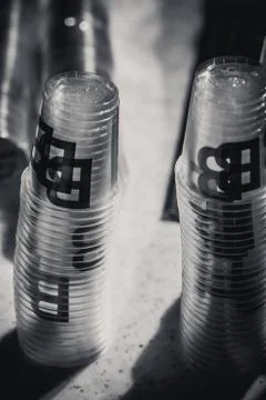Macro shot of plastic cups for degustation stacked on a table Stock Photos