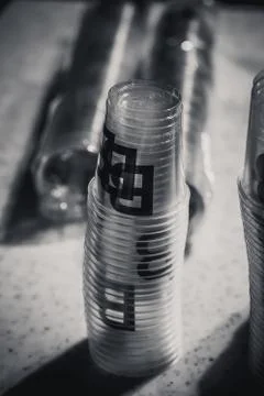 Macro shot of plastic cups for degustation stacked on a table Stock Photos
