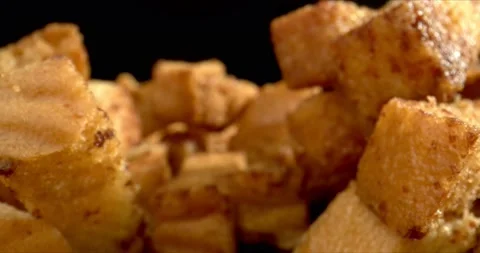 Macro shot of plate with crackers. Crackers Food Crisps Snacks close-up on black Stock Footage 148616815