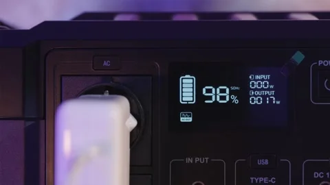 Macro shot of plugging cable into portable power station socket Stock Footage 334732365
