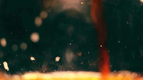 Macro shot of pouring beer with bubbles and foam into a glass goblet in macro Stock Footage 131103315