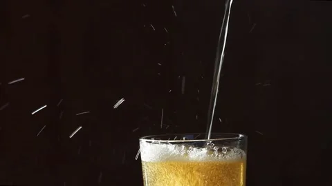 Macro Shot Of Pouring Light Beer Into Glass Stock Footage 142476467