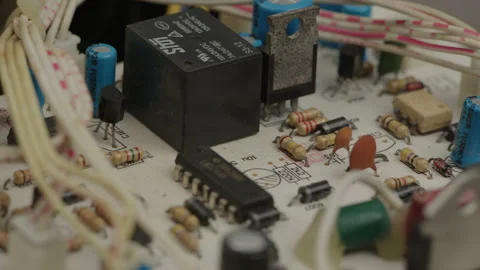 Macro shot of printed circuit board on table with various electronic components Stock Footage 202622556