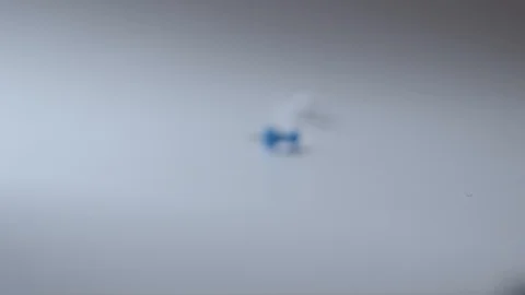 Macro shot of push pins rolling over a white surface Stock Footage 117350311