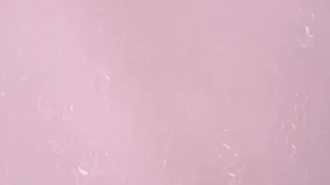 Macro shot of rain droplets on window. Water drops in window on light pink .. Stock Footage 271148205