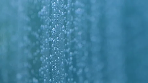 Macro Shot Of Rain Drops On Blue Glass Surface During Storm Stock Footage 345447889