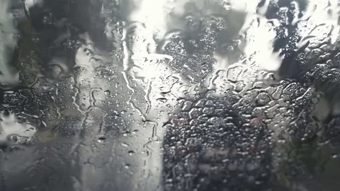 Macro shot of raindrops falling on windshield on a rainy day Stock Footage 83393860