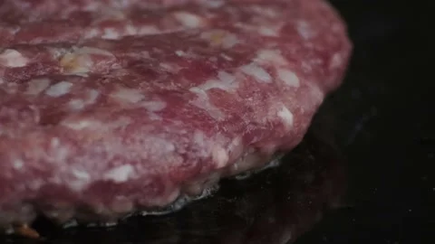 Macro shot of raw burger on grill. Process making burger. 動画素材 140326399