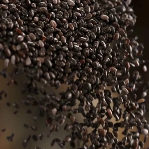 Macro Shot of Raw Organic Chia Seeds Falling and Pouring in Slow Motion Texture Stock Footage 322523943