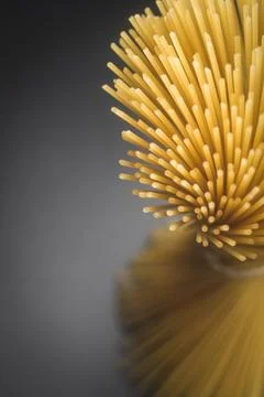 Macro Shot of Raw Spaghetti Pasta Bundle on Dark Background Stock Photos