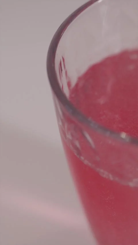 Macro shot of red bubbles rising in glass of vitamin drink Stock Footage 332724596