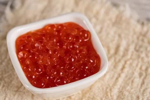 Macro shot of red caviar in small white bowl Stock Photos
