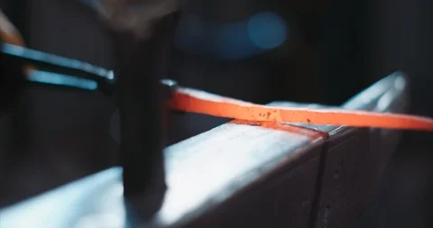 Macro shot of red hot iron being worked on Stock Footage 105295837