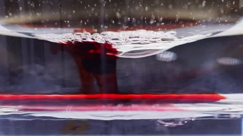 Macro shot of a red ink bubble dripping in water Stock Footage 124671201