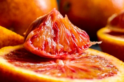 Macro shot of red mandarin slice on dark surfaces Stock Photos