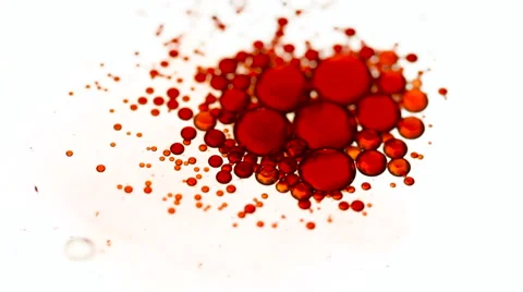 Macro shot of red oil drops swimming on water Stockbeeldmateriaal 55510997