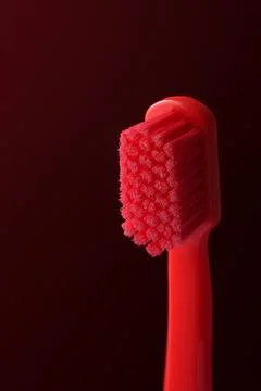 Macro shot of a red toothbrush. Dramatic photo with detail of the bristles. S Stock Photos