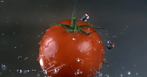Macro shot of ripe red fresh tomato in the kitchen while cooking with pure water Video stock 269352224