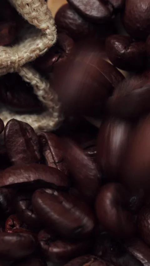 Macro Shot of Roasted Coffee Beans Spilling from Burlap Bag Stock Footage 345205806