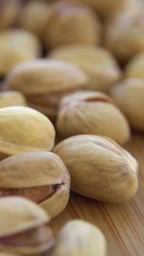 Macro shot of roasted pistachio nuts in hard shell Video stock 334171487