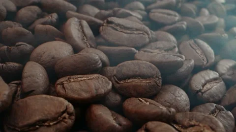Macro shot roasting coffee beans with smoke Video stock 229449312