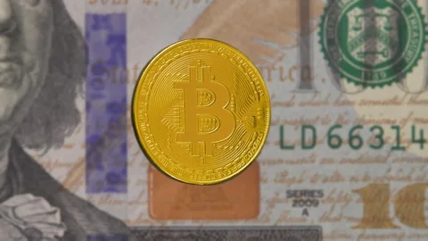 Macro shot of a rotating bitcoin against the background of dollar bills Stock Footage 198394357