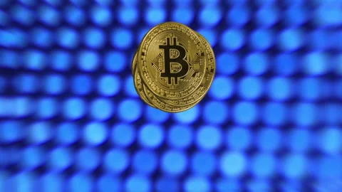 Macro shot of a rotating bitcoins on a blue abstract background. Crypto currency Stock Footage 198918544