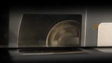 Macro Shot of Rotating Spool in a Digital Video Cassette Stock Footage 135011100