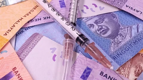 Macro shot of rotating syringe with brand new Malaysian ringgit (MYR) banknotes. Stock Footage 297150528