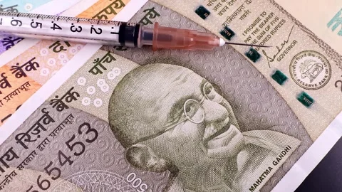 Macro shot of rotating syringe over indian rupee bills. Stock Footage 294598530