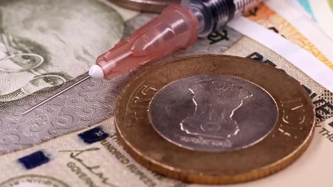 Macro shot of rotating syringe over indian rupee money. Stock Footage 294599318