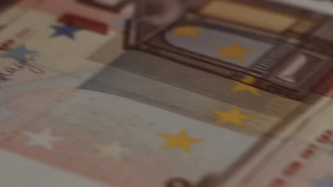 Macro shot of rows of euros with a dollar bill in the middle Stock Footage 79974919