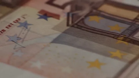 Macro shot of rows of euros with a dollar bill in the middle Stock Footage 79974924
