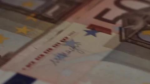 Macro shot of rows of euros with a dollar bill in the middle Stock Footage 79974926